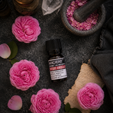 10 ml Rose Absolute Essential Oil — overhead lifestyle flat lay
