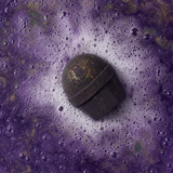 Emerald Oudh Truffle Bath Bomb · in-use fizz
